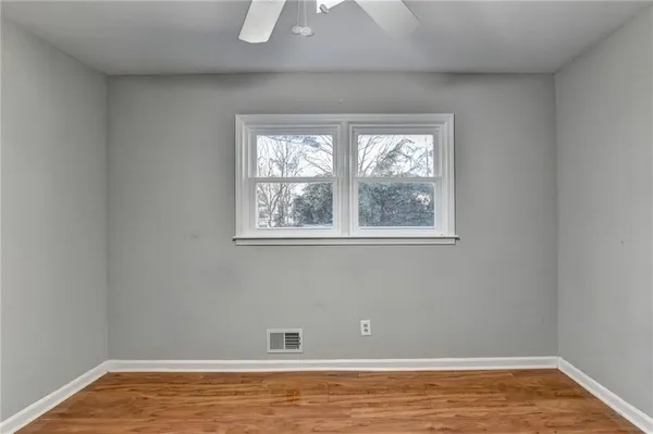 a view of room with window and wooden floor
