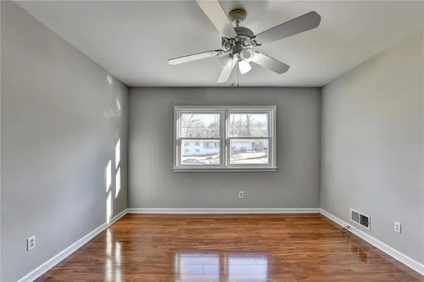 wooden floor in an empty room with a window