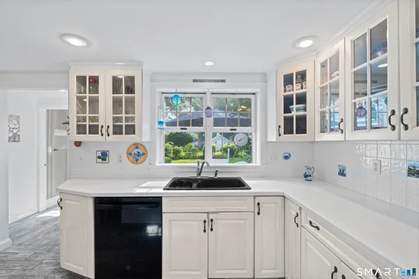 a kitchen with granite countertop a sink and cabinets