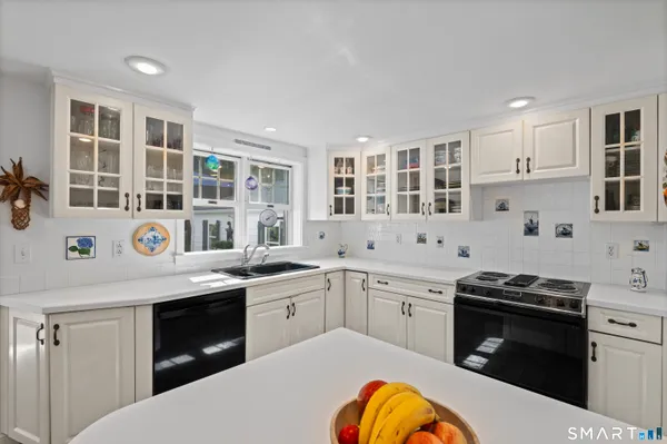 a kitchen with a sink stove and cabinets