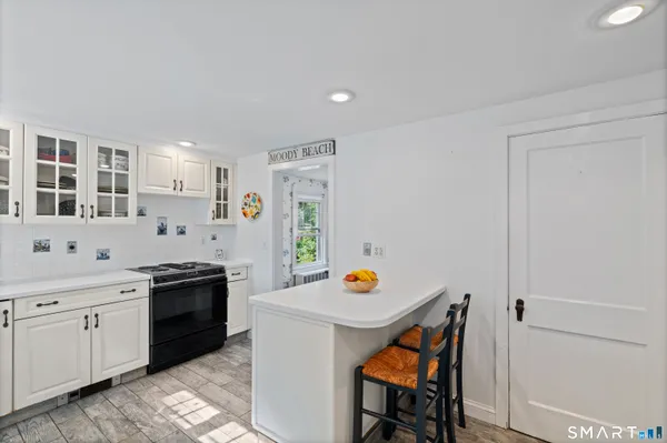 a kitchen with stainless steel appliances a stove a sink and a refrigerator