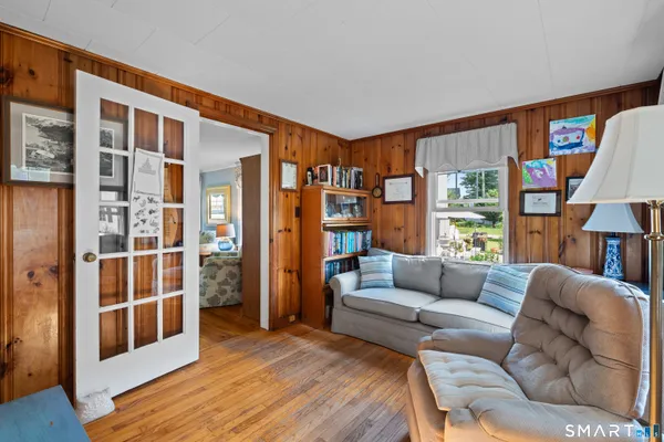 a living room with furniture a rug and a large window