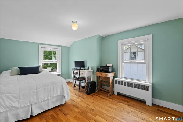 a bedroom with furniture and a window