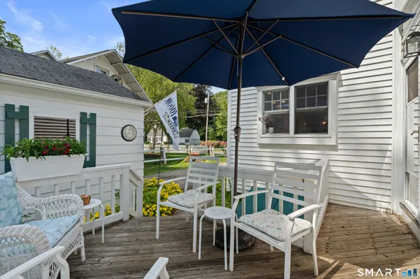 a backyard of a house with table and chairs
