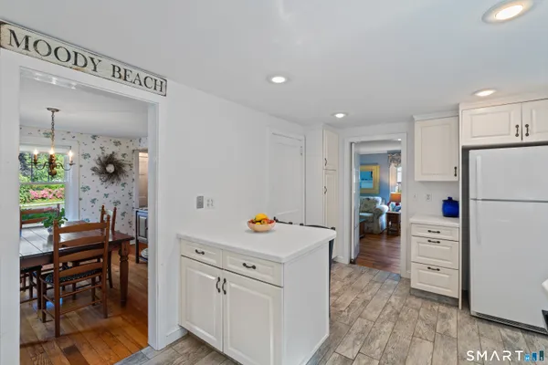 a kitchen with a refrigerator and a dining table