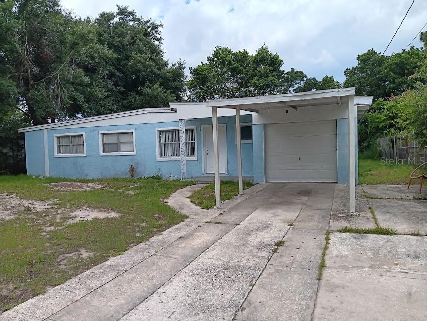 a view of a house with a yard and a garage