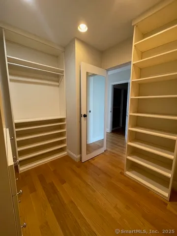 a view of room with stairs and wooden floor