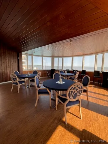 a view of residential houses with yard and road