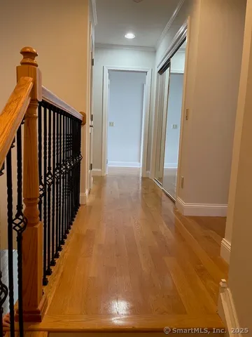 a view of a hallway with wooden floor