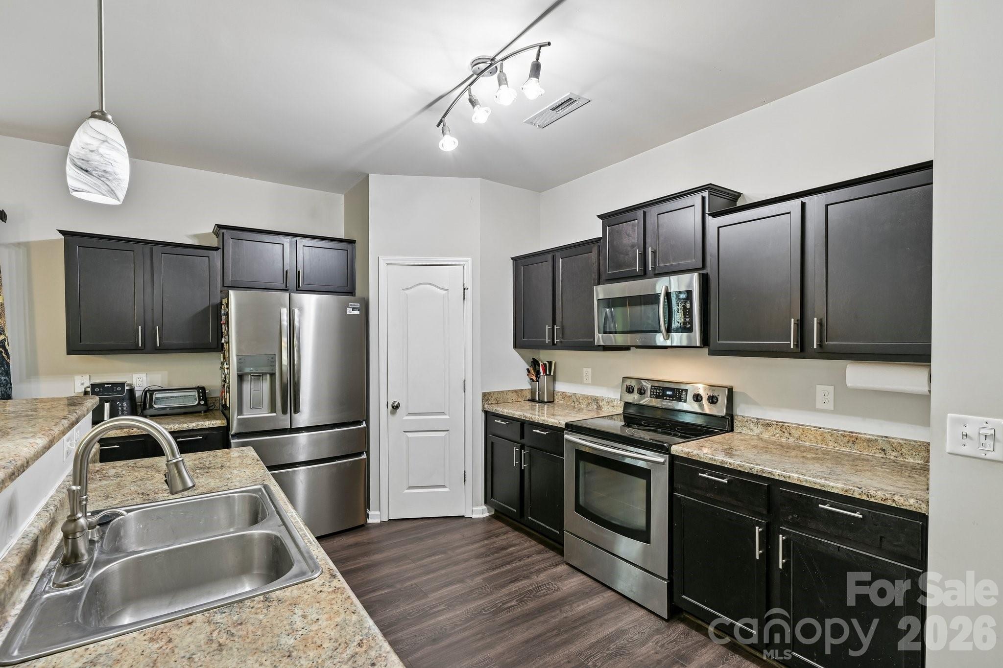 2206 Turtle Point Road Charlotte, NC 28262 - Photo 12 of 28 a kitchen with stainless steel appliances granite countertop a refrigerator a stove a sink dishwasher a refrigerator with a dining table and chairs