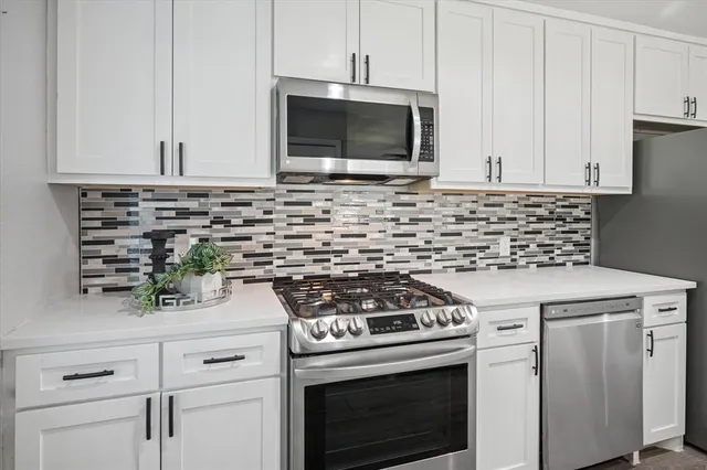 a kitchen with a sink stove and refrigerator