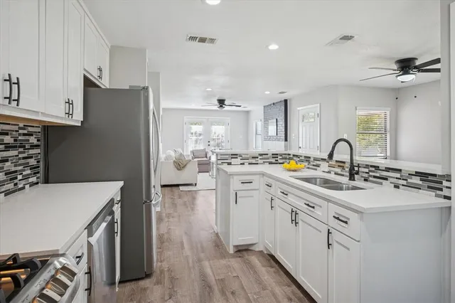 a kitchen with appliances cabinets and a sink