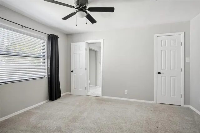 a kitchen with a table chairs and a refrigerator