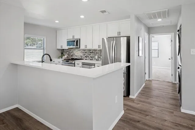 a dining room with wooden floor and a window