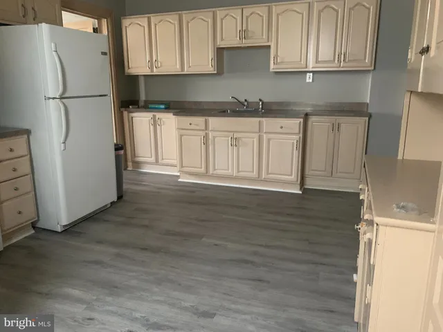a kitchen with stainless steel appliances granite countertop a refrigerator sink and cabinets