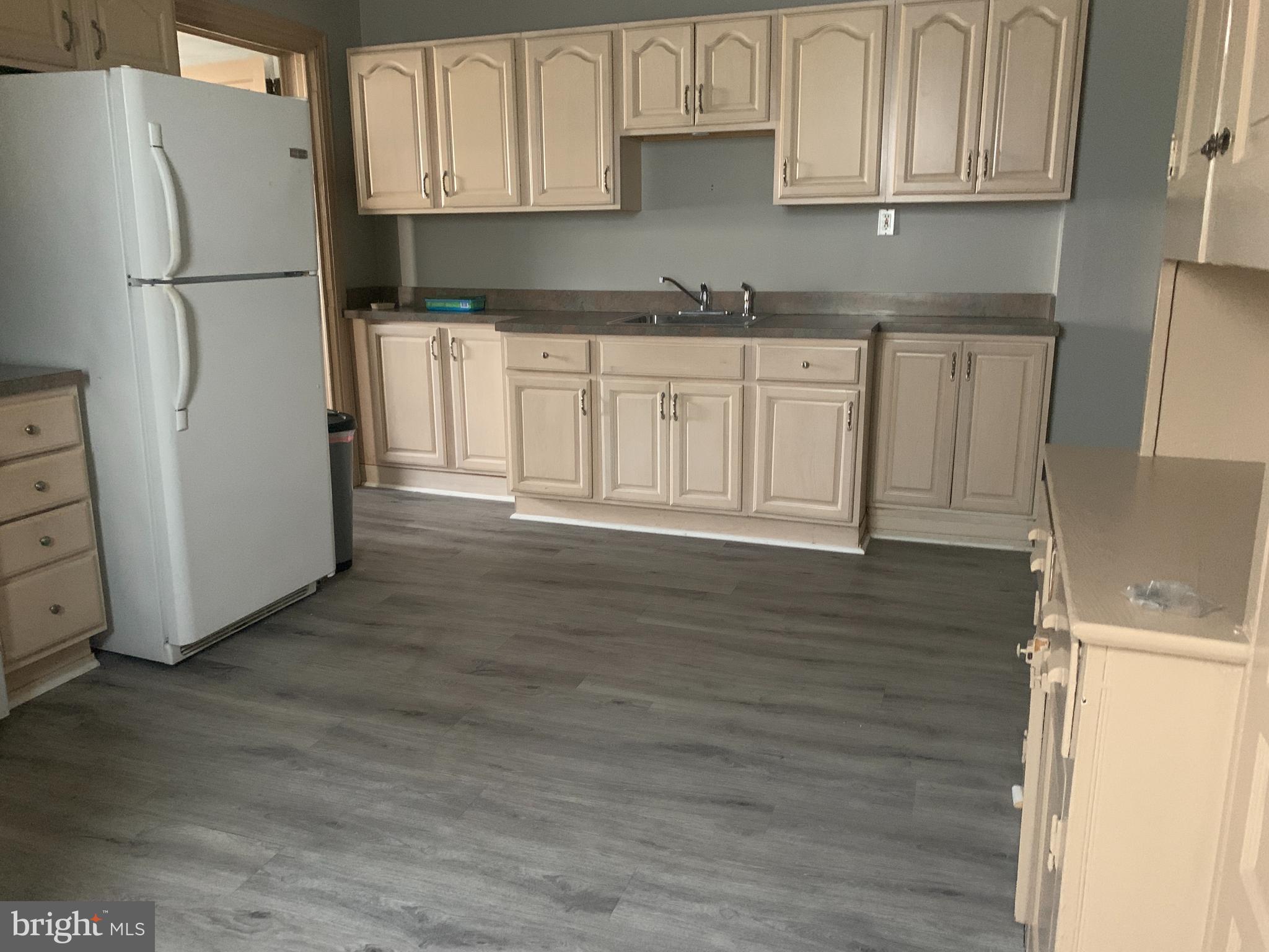 340 Main Street, Unit FIRST Royersford, PA 19468 - Photo 4 of 10 a kitchen with stainless steel appliances granite countertop a refrigerator sink and cabinets