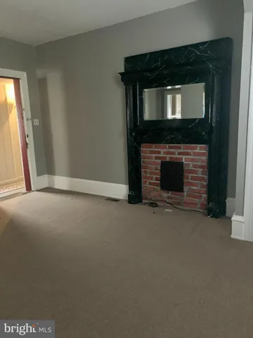 a view of empty room with a fireplace