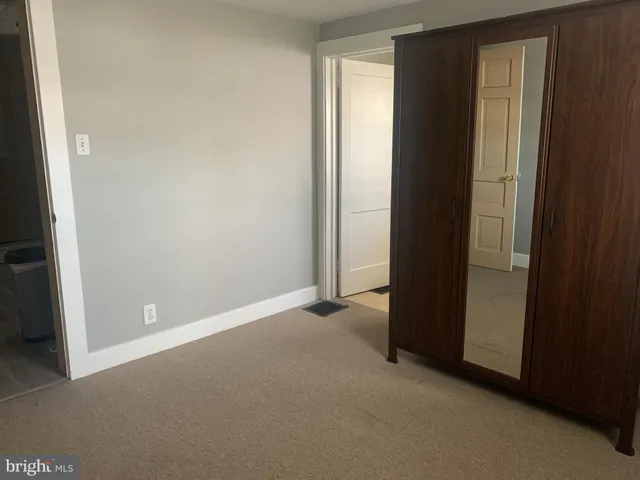 an empty room with closet and entrance