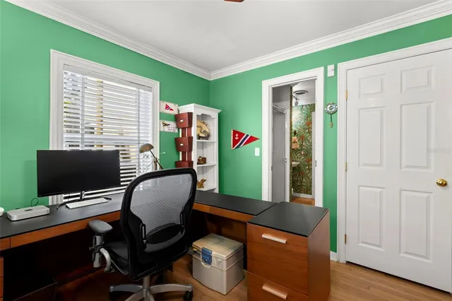 a kitchen with granite countertop a stove and white cabinets