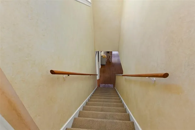 a bedroom with a bed and a lamp on a dresser