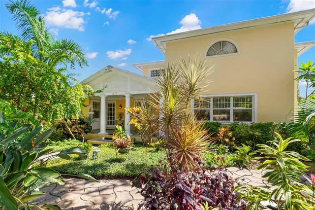 a living room with furniture and large windows