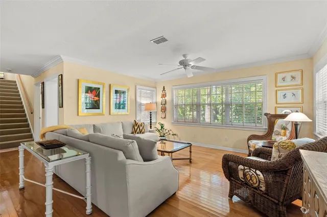 a living room with furniture a window and a flat screen tv