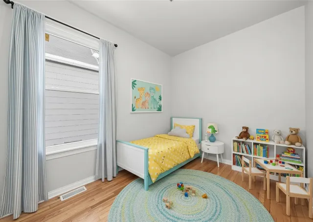 a view of a room that has wooden floor and a window
