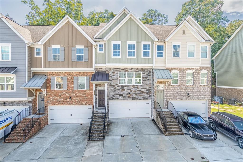 a view of a brick house with many windows and a water fountain