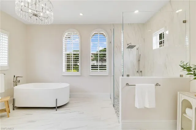 a spacious bathroom with a tub sink and shower