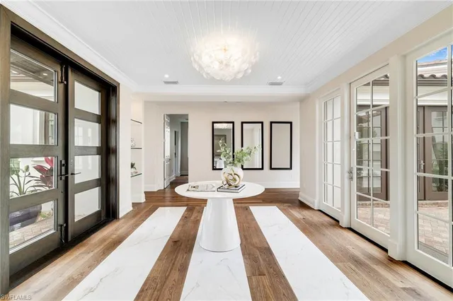 a view of a very nice looking living room with a large window and chandelier