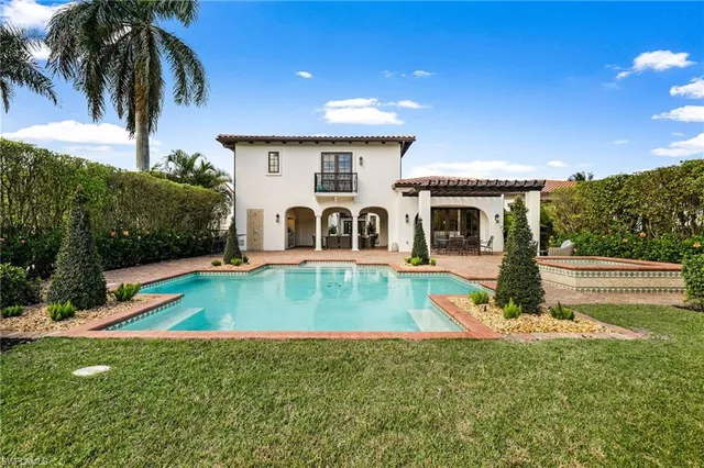 a view of a house with swimming pool and a yard