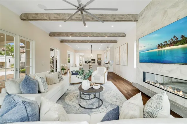 a living room with furniture and a chandelier