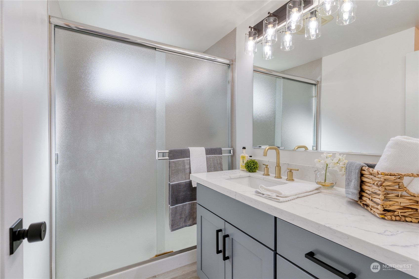 3749 Southwest Monroe Street Seattle, WA 98126 - Photo 11 of 25 a bathroom with a granite countertop sink a mirror and a shower
