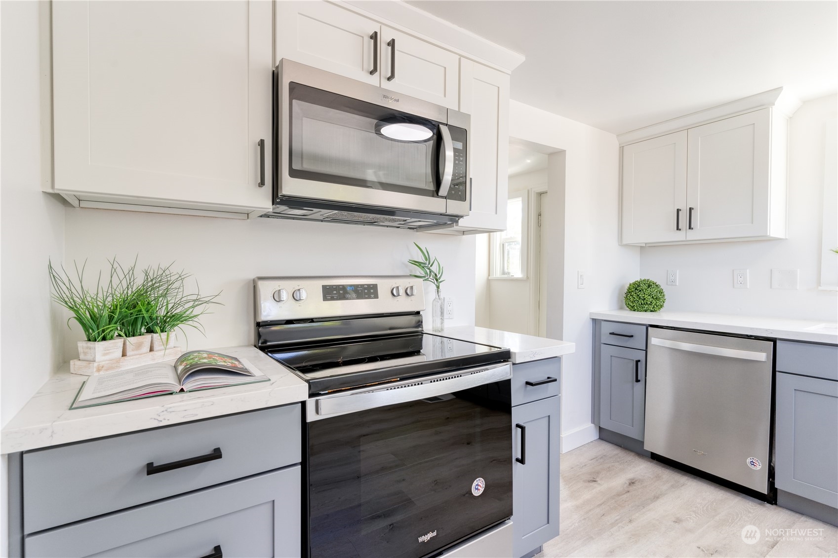 3749 Southwest Monroe Street Seattle, WA 98126 - Photo 13 of 25 a kitchen with white cabinets stainless steel appliances and potted plant