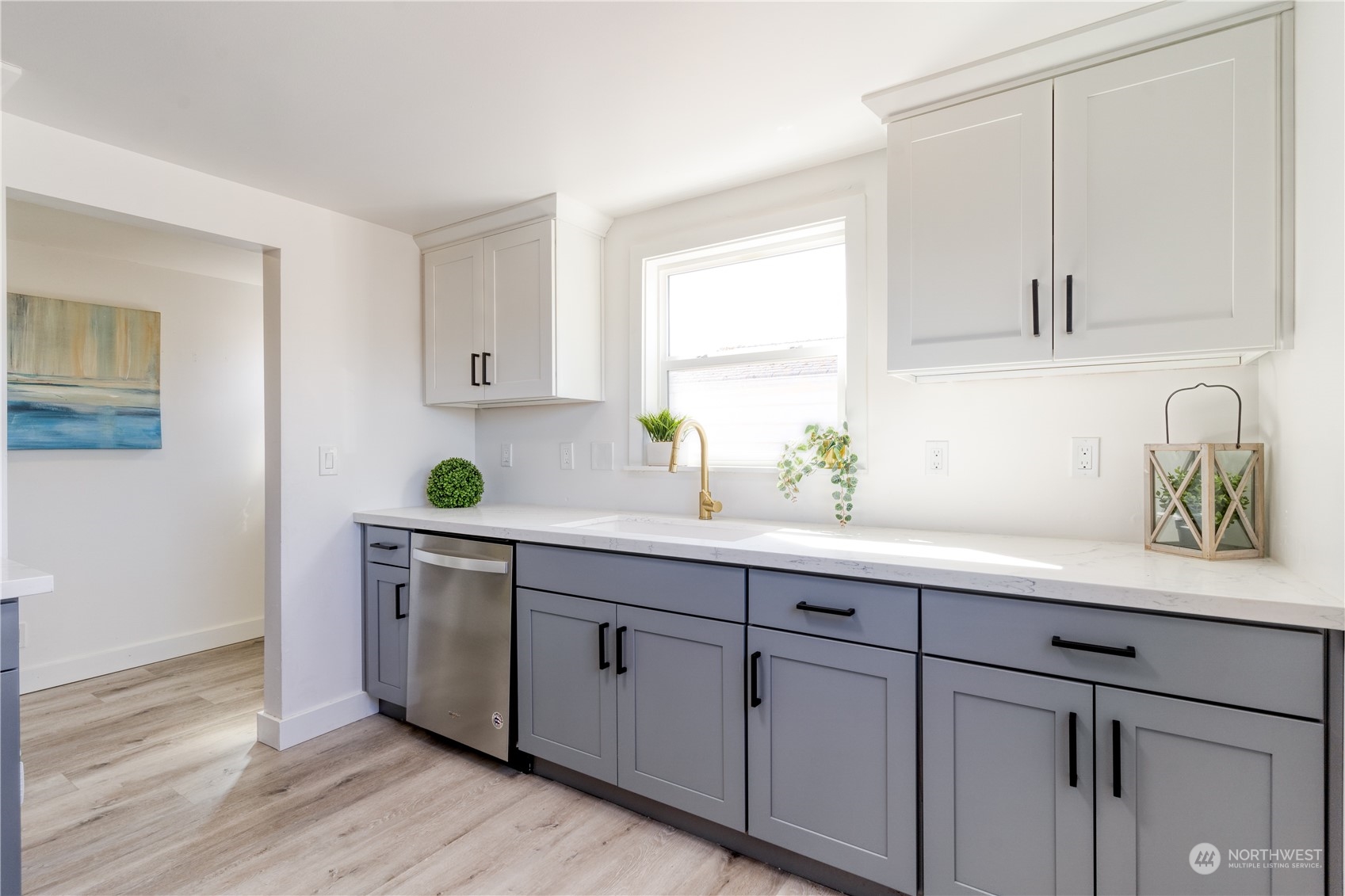 3749 Southwest Monroe Street Seattle, WA 98126 - Photo 14 of 25 a kitchen with stainless steel appliances white cabinets and a window