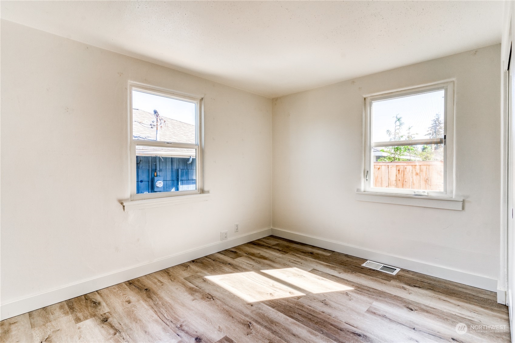 3749 Southwest Monroe Street Seattle, WA 98126 - Photo 7 of 25 an empty room with wooden floor and windows