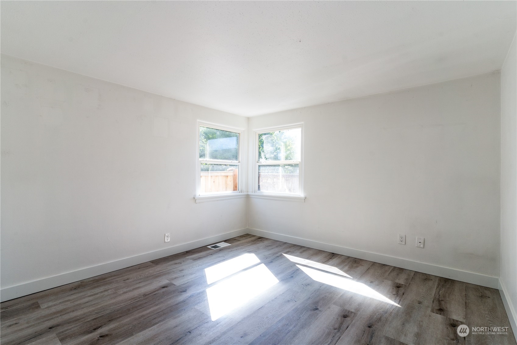 3749 Southwest Monroe Street Seattle, WA 98126 - Photo 9 of 25 an empty room with wooden floor and windows