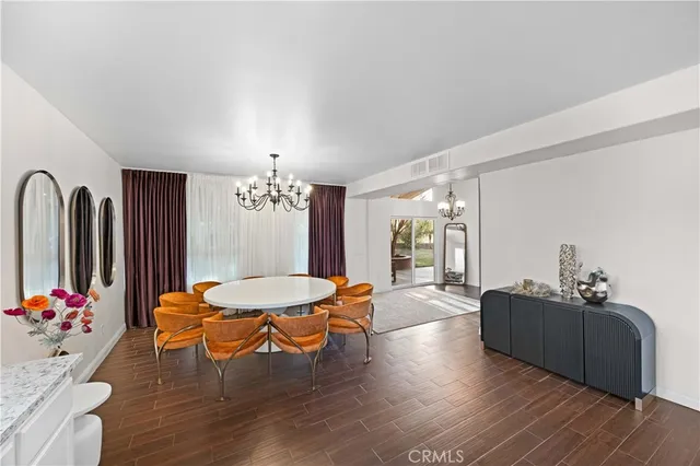 a living room with furniture a dining table and a fireplace