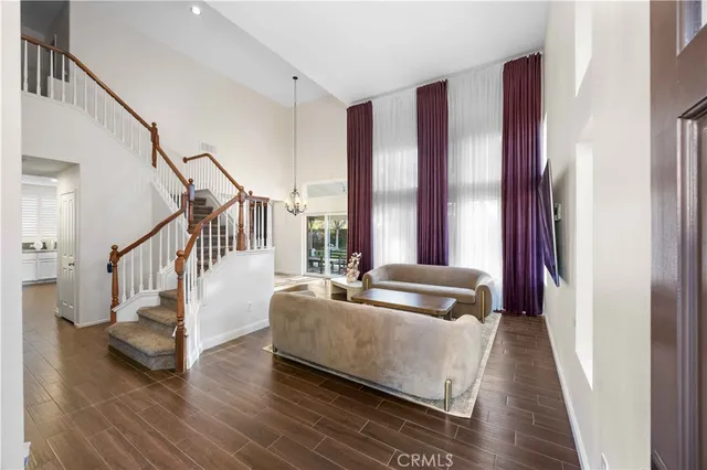 a living room with furniture and stairs