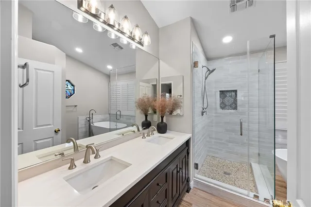 a bathroom with a sink shower and a mirror
