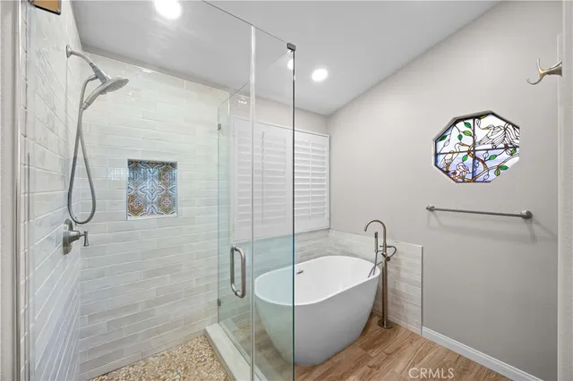 a bathroom with a bathtub and shower