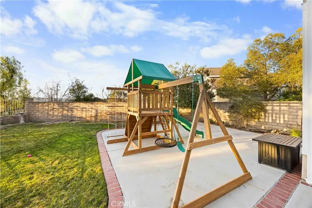 a view of a swimming pool with a bench and lawn chairs