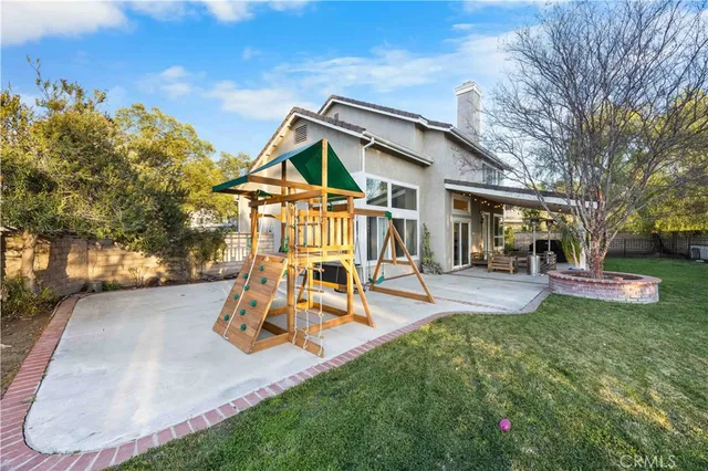 a view of a house with backyard porch and sitting area