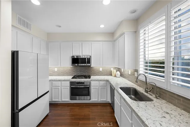 a kitchen with a stove sink and refrigerator