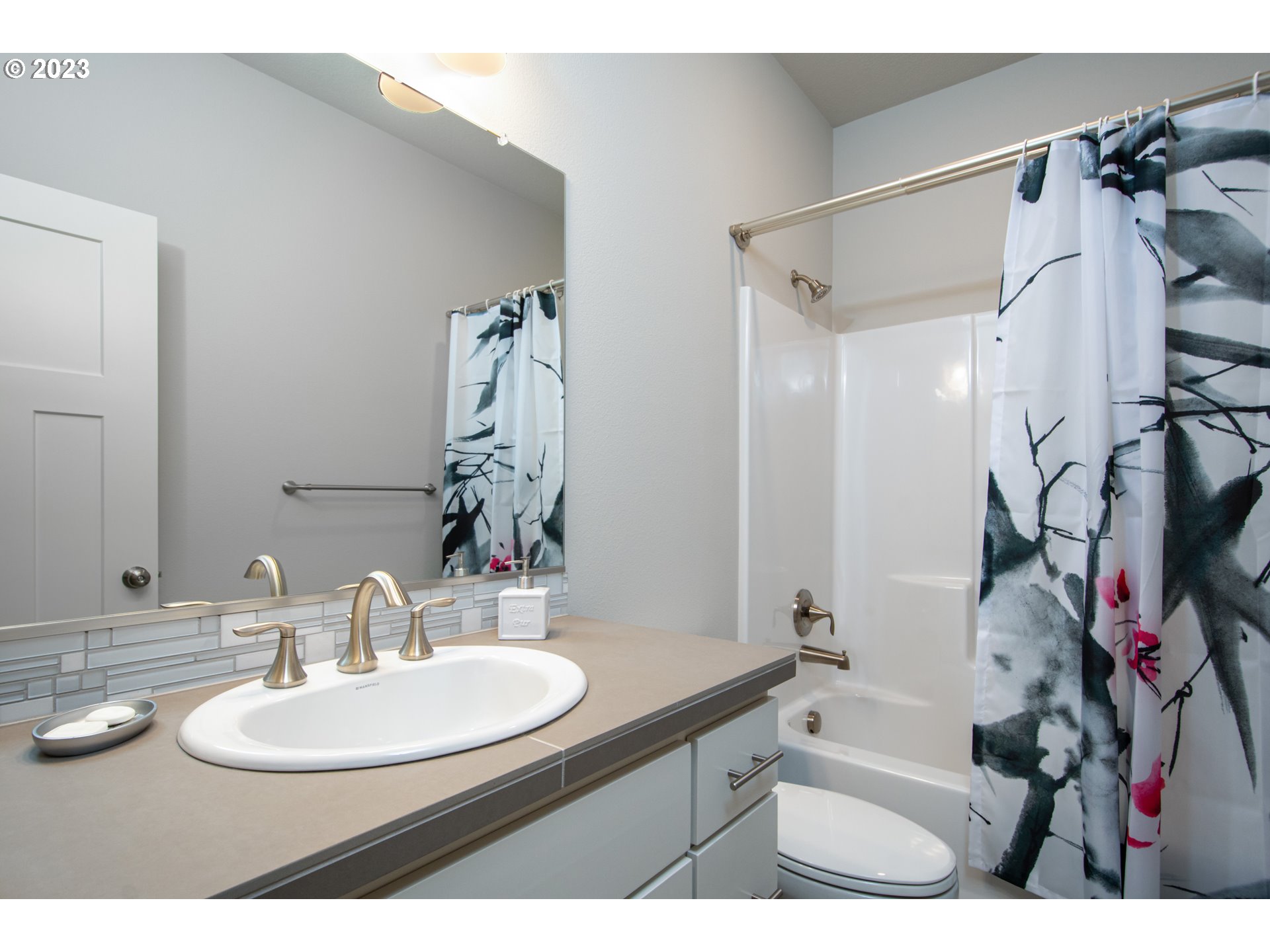 4916 South 17th Drive Ridgefield, WA 98642 - Photo 17 of 26 a bathroom with a sink vanity mirror and shower