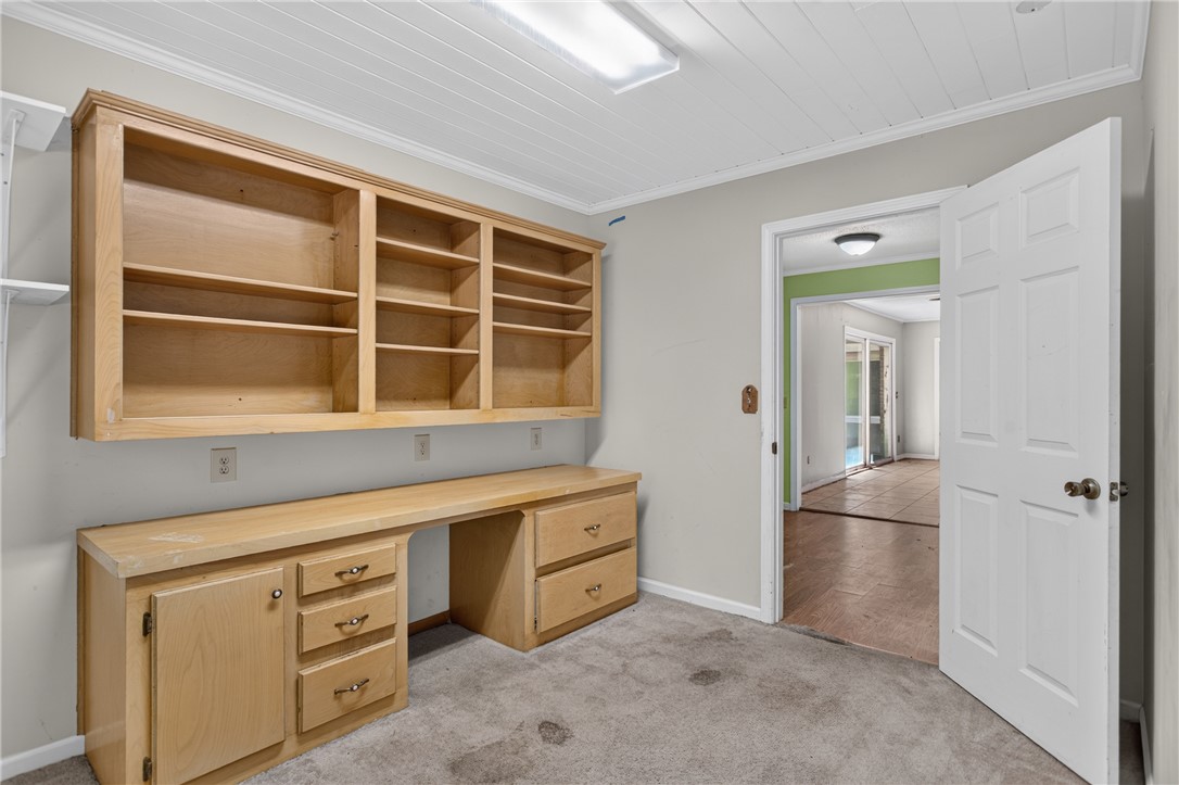 123 Robin Road Westminster, SC 29693 - Photo 39 of 50 An inviting office space with built-in wooden shelving and a spacious desk offers practical utility.