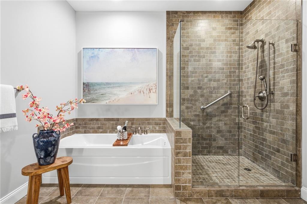 270 17th Street Northwest, Unit 4306 Atlanta, GA 30363 - Photo 27 of 37 a bathroom with a bathtub and shower