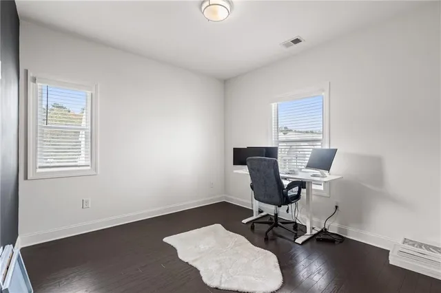 a view of house with wooden floor and a floor to ceiling window