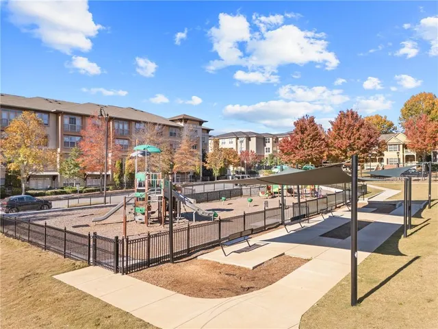 a view of a house with large windows and a small yard