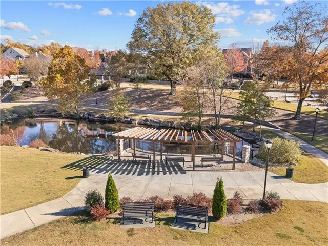 a view of a patio with table and chairs potted plants